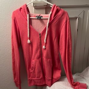 Zip up hooded jacket. Size large. Form fitting. Lace cut out sleeves.